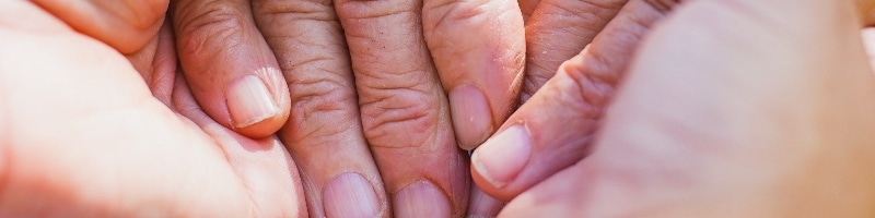 parkinsons-patient-holding-hands-resized